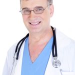 happy laughing mature male doctor with stethoscope